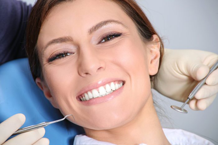 Woman smiling during a cosmetic dental consultation at the dentist asheville nc