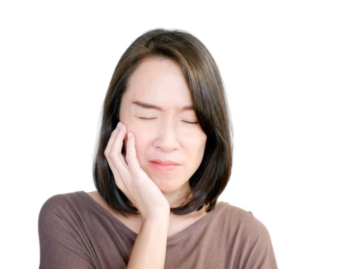 Woman suffering from toothache red maple dental asheville nc