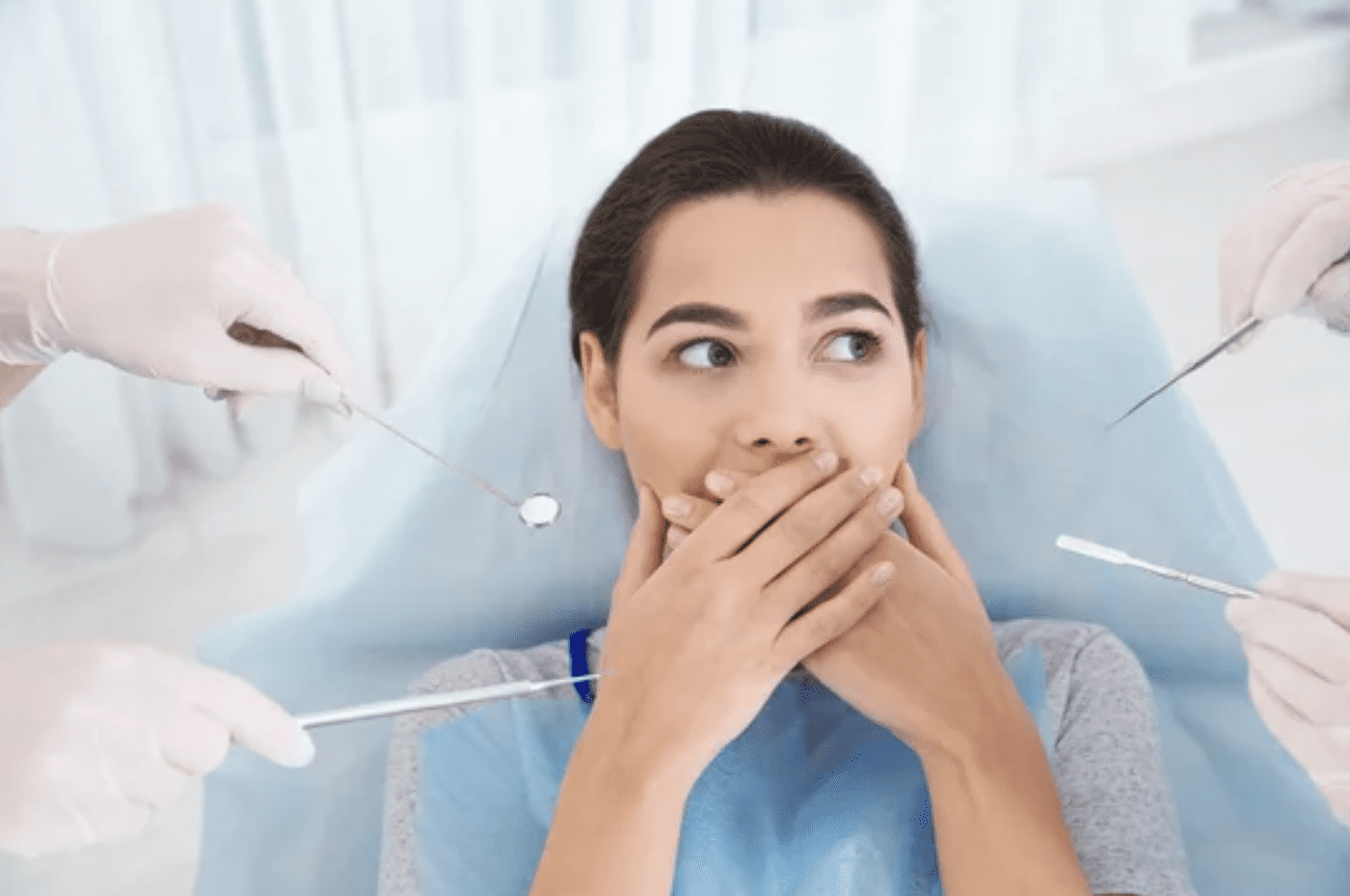 scared woman blocking her mouth from dental procedure sedation dentistry Asheville North Carolina